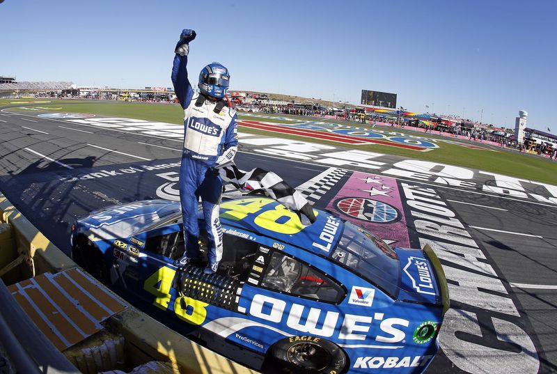 Jimmie Johnson celebrates on Sunday after becoming the first driver to win four Bank of America 500 NASCAR Sprint Cup Series races at Charlotte Motor Speedway.