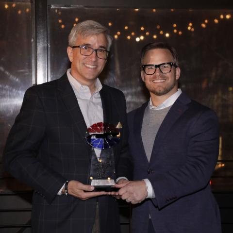 Speedway Motorsports President and CEO Marcus Smith, right, presented Charlotte Motor Speedway Executive Vice President and General Manager Greg Walter with Speedway Motorsports' Promoter of the Year award.