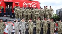 Military members stand and salute during the pre-race festivities at the Coca-Cola 600 at Charlotte Motor Speedway.