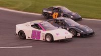 Bandoleros race three-wide during Round 6 of the Bojangles' Summer Shootout at Charlotte Motor Speedway.