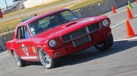 A vintage Mustang shows a little muscle on the AutoCross course during opening day of the 22nd annual Goodguys Southeastern Nationals at Charlotte Motor Speedway.