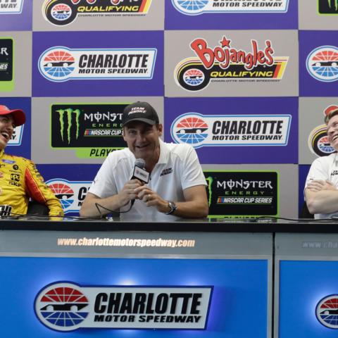 Monster Energy NASCAR Cup Series champion Joey Logano, left, shares a laugh with IndyCar Series champion Josef Newgarden, right, while Team Penske President Tim Cindric, center, answers a question during a press conference on Friday at Charlotte Motor Speedway.