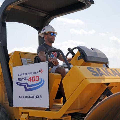 NASCAR driver Bubba Wallace traded his driving helmet for a hard hat on Tuesday at Charlotte Motor Speedway.