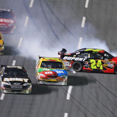 Tony Stewart, top left, was in fifth place in the closing laps of the 2009 Monster Energy NASCAR All-Star Race at Charlotte Motor Speedway. Once a crash removed Jeff Gordon, right, and Ryan Newman, bottom left, from contention, Stewart cleared Kyle Busch and Matt Kenseth for the win.