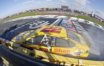 Joey Logano celebrates winning the Bank of America 500, his first Sprint Cup Series win at Charlotte Motor Speedway.