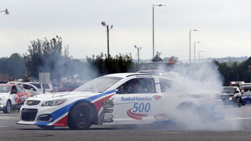 NASCAR driver Clint Bowyer smokes his tires during a burnout at Charlotte Motor Speedway's Parade of Power on Wednesday.