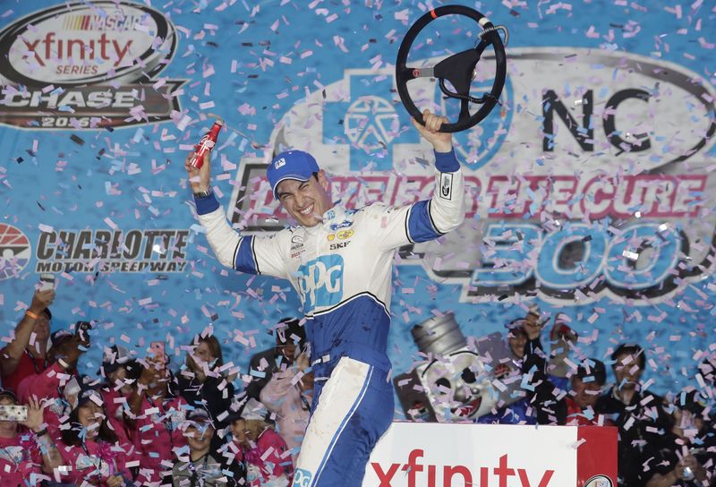 Joey Logano celebrates after winning Sunday's NASCAR XFINITY Series Drive for the Cure 300 presented by Blue Cross and Blue Shield of North Carolina at Charlotte Motor Speedway.