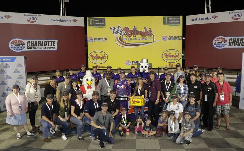 Denny Hamlin celebrates after winning the pole for Sunday's Bank of America 500 at Charlotte Motor Speedway.