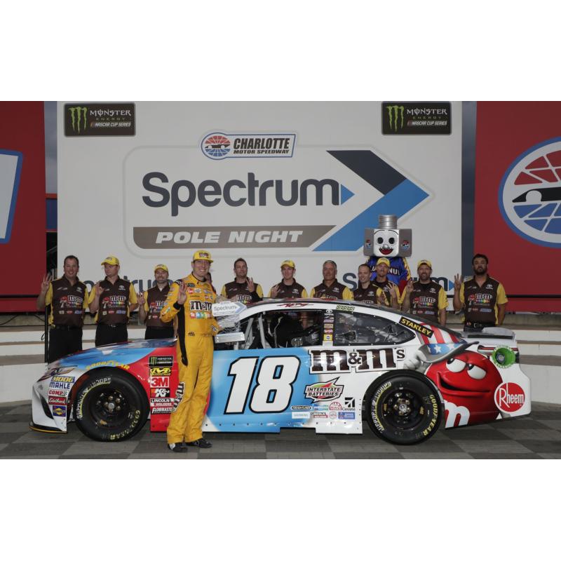 Coca-Cola 600 pole winner Kyle Busch poses with his team after his 191.836-mph lap was fastest on Thursday's Spectrum Pole Night at Charlotte Motor Speedway.