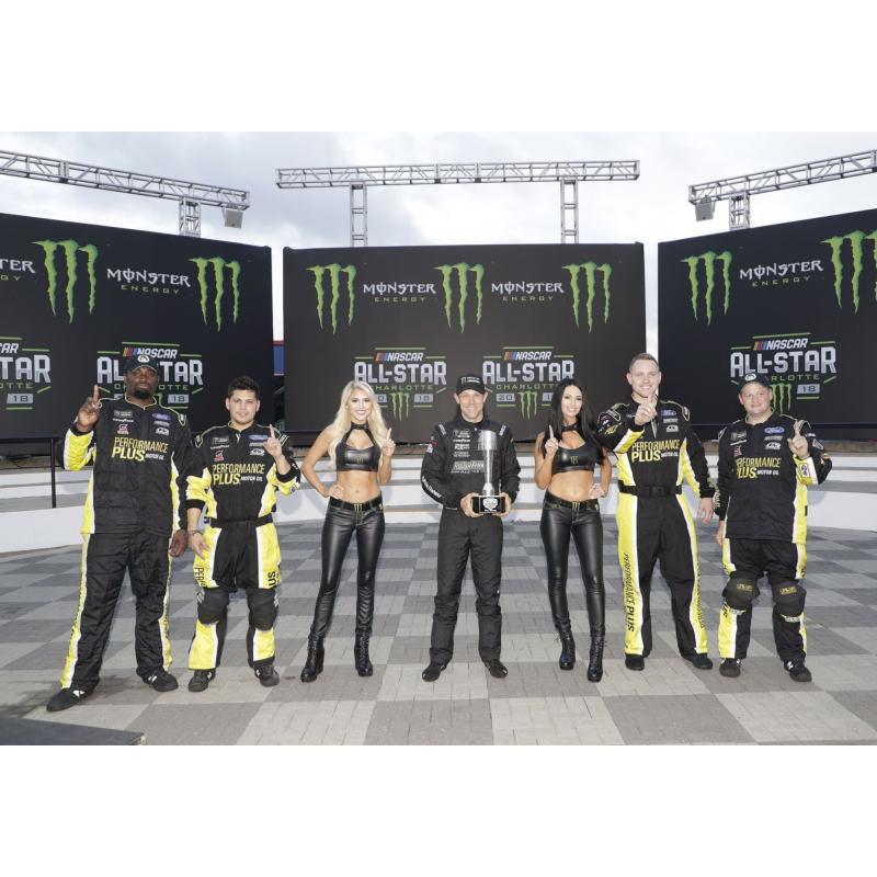 Matt Kenseth, middle, cleebrates with Roush Fenway Racing crew members and Monster Energy girls after winning the pole for the Monster Energy NASCAR All-Star Race at Charlotte Motor Speedway.