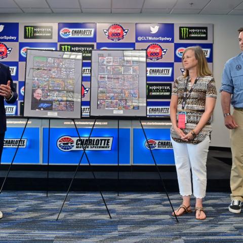 Denise Bass, the wife of NASCAR artist Sam Bass, receives recognition by Speedway Motorsports President and CEO Marcus Smith during pre-race events for the Coca-Cola 600.