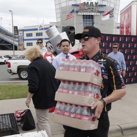 NHRA Top Fuel driver Austin Prock took part in Charlotte Motor Speedway's "I Love My City" event on Thursday at zMAX Dragway. The speedway partnered with Coca-Cola Consolidated and Cooperative Christian Ministries to donate more than 800 cases of Coca-Cola products to public safety organizations.