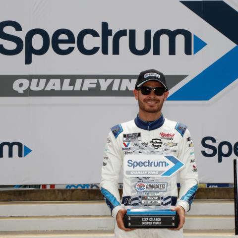 Kyle Larson holds his Spectrum Qualifying trophy after winning the pole for Sunday's Coca-Cola 600 at Charlotte Motor Speedway.