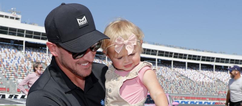 Blue Cross NC brand ambassador and Joe Gibbs Racing Xfinity Series driver Daniel Hemric gets help from his daughter, Rhen, in painting Charlotte Motor Speedway's pit wall pink alongside dozens of breast cancer survivors on Tuesday during an event to promote the upcoming Drive for the Cure 250 presented by Blue Cross Blue Shield of North Carolina on Oct. 9. 