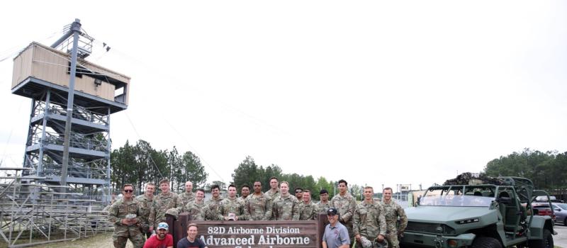 Members of the 1st Brigade Combat Team pose for a photo with Coca-Cola Racing Family driver Austin Dillon and his Richard Childress Racing teammate Tyler Reddick during a Mission 600 visit to the U.S. Army Advanced Airborne School at Fort Bragg.
