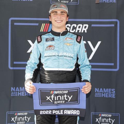 Sam Mayer holds his NASCAR Xfinity Series pole award after qualifying first for Saturday's Alsco Uniforms 300 at Charlotte Motor Speedway.