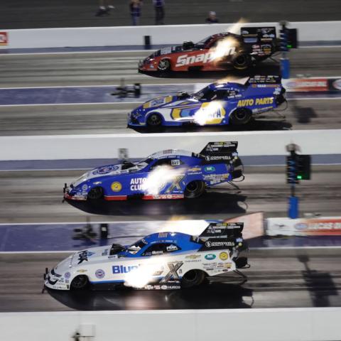 John Force, Robert Hight, Ron Capps and Cruz Pedregon make a Funny Car qualifying pass during Friday’s Night of Fire during the Circle K NHRA Four-Wide Nationals at zMAX Dragway. 