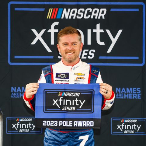 Justin Allgaier poses on Friday after winning the pole for Saturday's Alsco Uniforms 300 NASCAR Xfinity Series race at Charlotte Motor Speedway. 