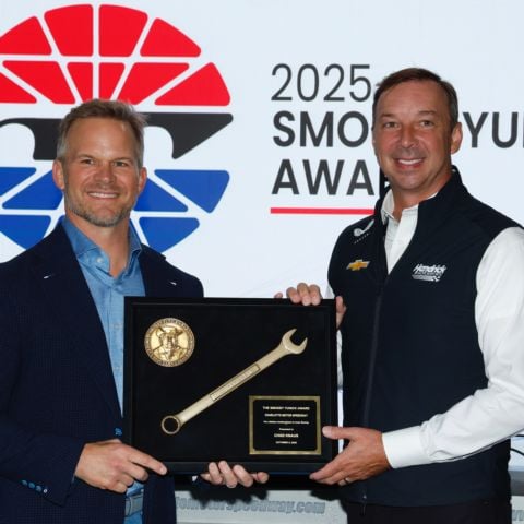 Speedway Motorsports President and CEO Marcus Smith, left, presents the Smokey Yunick Award to Hendrick Motorsports Vice President of Competition Chad Knaus on Sunday at Charlotte Motor Speedway.
