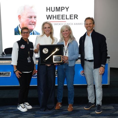 Patti Wheeler (second from left) accepted the 2026 Smokey Yunick Award on behalf of her father, Humpy Wheeler, from Speedway Motorsports President and CEO Marcus Smith (right) and Charlotte Motor Speedway General Manager Jessica Fickenscher (left) Sunday at Charlotte Motor Speedway.