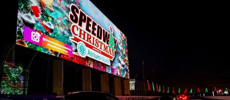 Charlotte Motor Speedway's 16,000-square-foot HDTV will come to life every Thursday through Sunday during Speedway Christmas presented by Atrium Health to showcase larger-than-life Christmas classic, drive-in movies. 