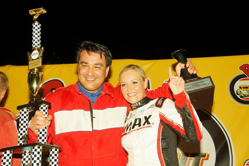 FOX 46 Carolinas' Anthony Flores, left, celebrates after winning the Media Mayhem school bus race during Tuesday's Bojangles' Summer Shootout action at Charlotte Motor Speedway. 