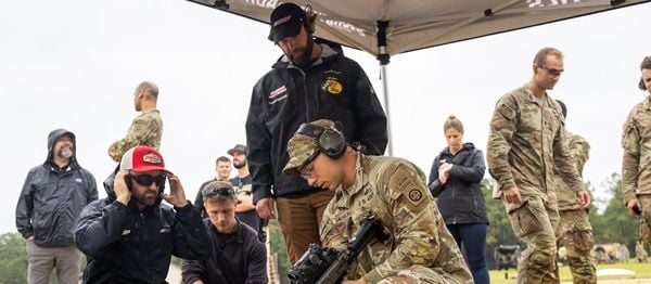 Coca-Cola Racing Family driver Austin Dillon and his Richard Childress Racing fueler, Tyler Rader, learn about the M249 SAW machine gun during a weapons demonstration as part of their Mission 600 visit to Fort Bragg.