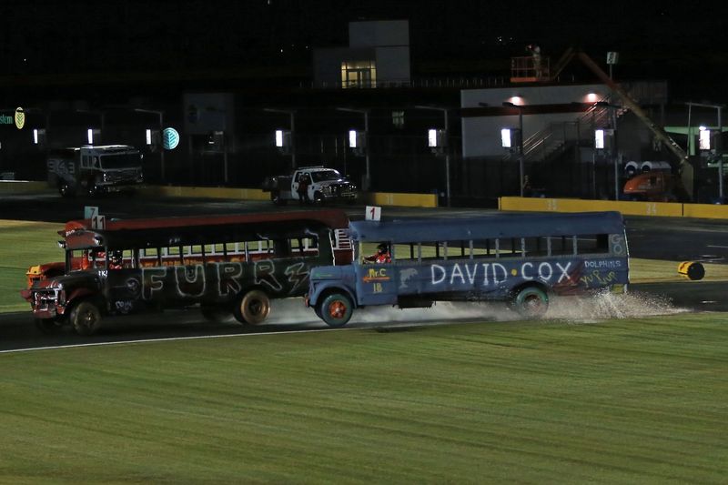 David Cox Road Elementary School Assistant Principal Charlie Copeland, right, battles with Carl A. Furr Elementary Principal Darin Roberts during Tuesday's Bojangles' Summer Shootout action at Charlotte Motor Speedway. Copeland passed Roberts and won the principal bus race.