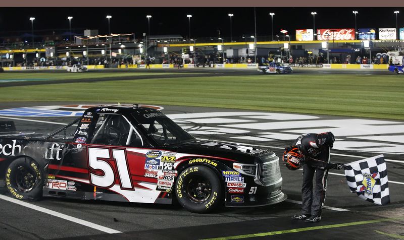 N.C. Education Lottery 200 winner Kyle Busch takes a bow after claiming his seventh NASCAR Camping World Truck Series win at Charlotte Motor Speedway on Friday.