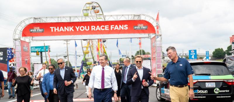 N.C. Gov. Roy Cooper (center), Speedway Motorsports President and CEO Marcus Smith (second from right) and NASCAR broadcaster Michael Waltrip (far right) tour the all-new Circle K Speed Street at Charlotte Motor Speedway ahead of Friday's opening day. 