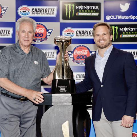 NASCAR Hall of Fame inductee Darrell Waltrip, left, receives a commemorative Bruton Smith Trophy from Speedway Motorsports, Inc. President and CEO Marcus Smith on Thursday at Charlotte Motor Speedway. Waltrip won a record five Coca-Cola 600s in his storied driving career.