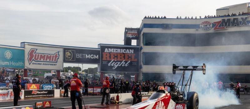 Top Fuel's Doug Kalitta powered his 11,000-horsepower machine to a track record 3.646-second pass to claim the provisional No. 1 qualifier spot in Friday's action at the American Rebel Light NHRA 4-Wide Nationals at zMAX Dragway.