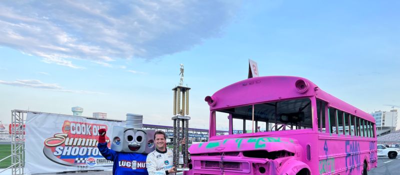 Kaulig Racing's Landon Cassill celebrates after beating his teammates and team president in a school bus slobberknocker during Round 10 of the Cook Out Summer Shootout at Charlotte Motor Speedway. 