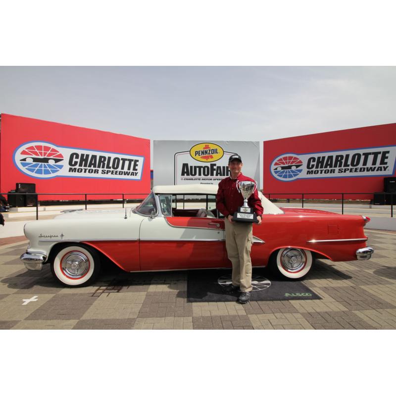 H.A. Mergen poses beside his 1955 Oldsmobile Starfire after winning the Walt Hollifield Best of Show award on Sunday at the Pennzoil AutoFair presented by Advance Auto Parts at Charlotte Motor Speedway.