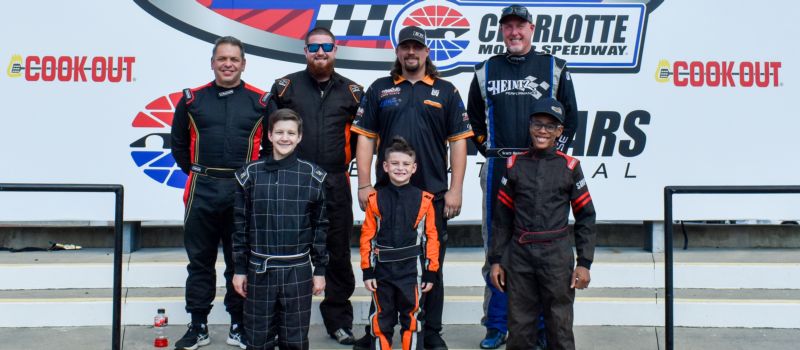 (L-R) Old Armor Beer Co. Masters Driver Dean Bonessi, Cameron White, NASCAR Xfinity Driver Josh Williams, Scott Heintz (Bottom Row) Bobby Mares, Gerald White III and LaQuan McCoy at Charlotte Motor Speedway on Tuesday, July 25, 2023.