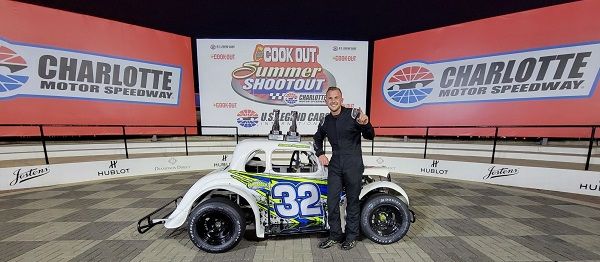Boston Reid & Co. Pro driver Jensen Jorgensen poses in victory lane with two Cook Out Summer Shootout trophies after winning both the rain-delayed Round 5 and Round 6 features Tuesday night at Charlotte Motor Speedway.