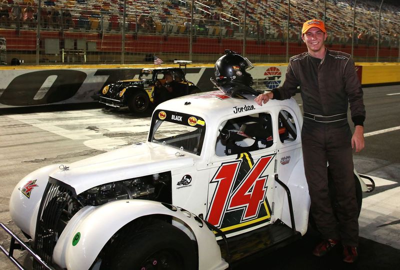 Jordan Black poses with his car after winning his third consecutive Lead 2 Real Estate Pro division feature in Tuesday's Bojangles' Summer Shootout at Charlotte Motor Speedway.