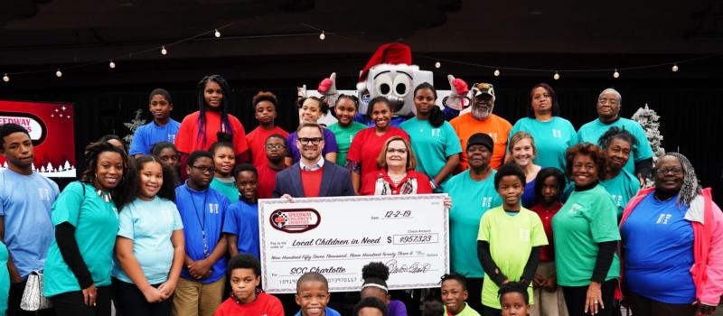 Speedway Children’s Charities Vice Chairman and Charlotte Chapter President Marcus Smith (center left) and Charlotte Chapter Director Lisa Starnes join children from area non-profits who were granted nearly $1 million during a special ceremony on Monday. 