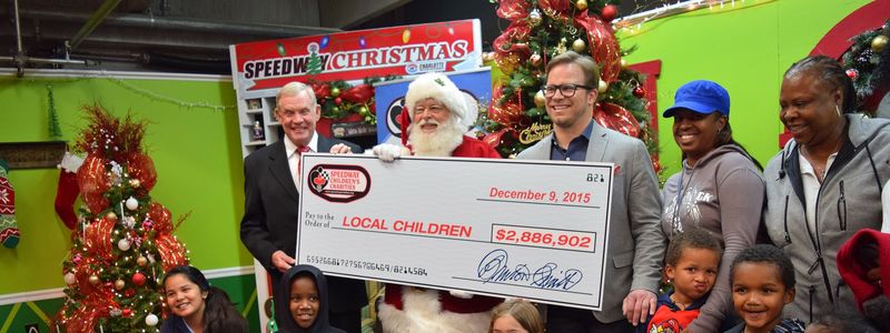 Speedway Children’s Charities President Marcus Smith and Executive Director Chuck Swannack display the check for nearly $2.9 million that was raised across all eight SMI tracks in 2015