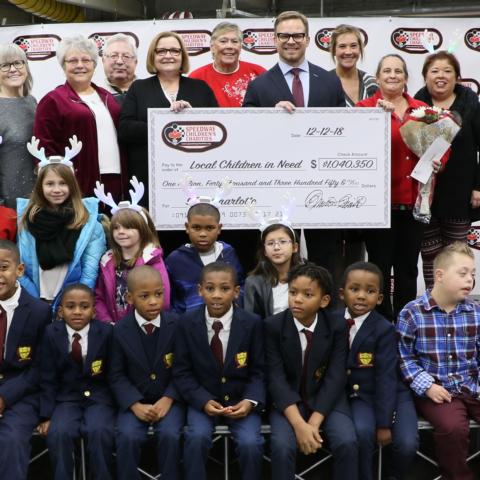 Speedway Children’s Charities Vice Chairman and Charlotte Chapter President Marcus Smith, fourth from right on the top row, poses with Speedway Children's Charities Charlotte Chapter employees and grant recipients at a special presentation on Wednesday at Charlotte Motor Speedway.