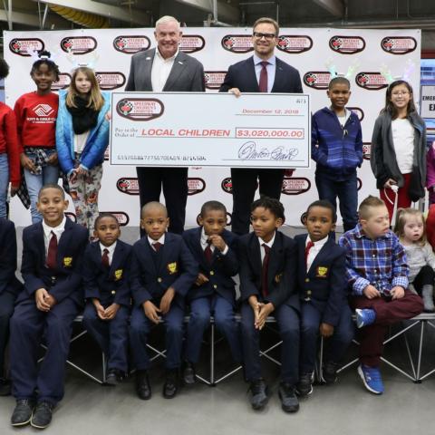 Speedway Children's Charities Vice Chairman and Charlotte Chapter President Marcus Smith, fourth from right on the top row, joins Speedway Children's Charities Executive Director Maj. Gen. Chuck Swannack, fourth from left on the top row, along with grant recipients at a special presentation on Wednesday at Charlotte Motor Speedway.