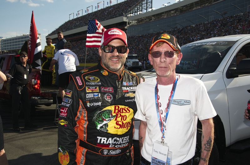 Tony Stewart poses with Ride of a Lifetime winner Michael Kiley during the 2015 Coca-Cola 600 pre-race show. 