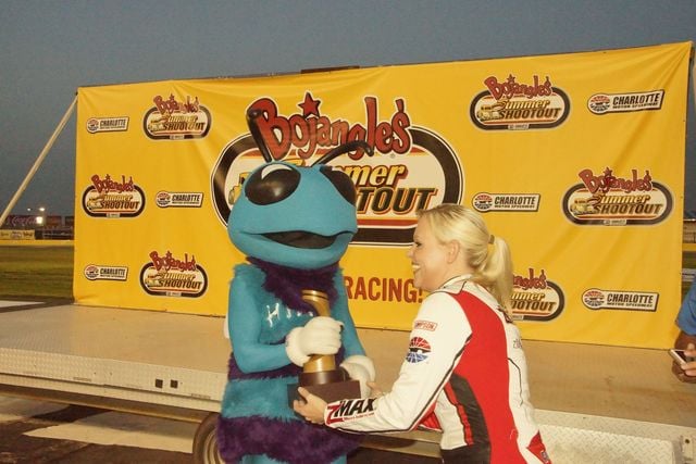 Hugo the Hornet claims his trophy after winning Tuesday's Mascot Mania race.
