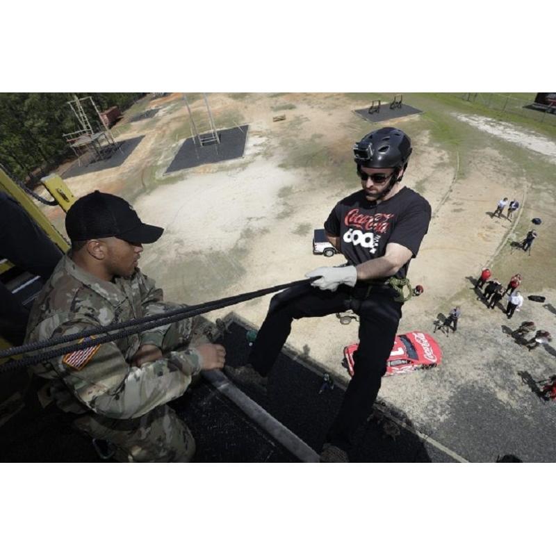 NASCAR driver Austin Dillon rappels from the 45-foot Air Assault Rappel Wall at Fort Bragg on Thursday. Dillon and his pit crew visited Fort Bragg for military exhibitions previewing Charlotte Motor Speedway's May 27 pre-race Salute to the Troops before the Coca-Cola 600.