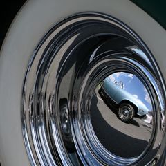 A classic muscle car reflected in the hubcap of a vintage pickup truck epitomizes the diversity of cars on display during the opening day of the Pennzoil AutoFair presented by Advance Auto Parts.