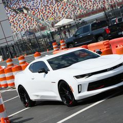 Fans test drive a Chevy Camaro and Chevy Silverado during the opening day of the Pennzoil AutoFair presented by Advance Auto Parts.