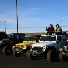 A pair of Jeep enthusiasts greet passers-by during the inaugural Cars and Coffee Concord at Charlotte Motor Speedway.