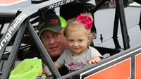 Dirt Late Model driver Matt Long shares a special moment with his daughter during the eighth annual Parade of Power at Charlotte Motor Speedway.