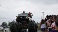 Fans wave as Sasquatch enters the speedway during the eighth annual Parade of Power at Charlotte Motor Speedway.