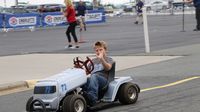 A young lawn mower racer was all smiles during the eighth annual Parade of Power at Charlotte Motor Speedway.
